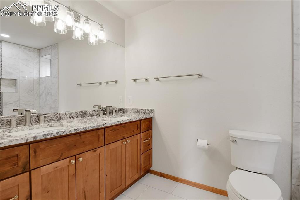 13771 South Hedi Road Sedalia, CO 80135 - Photo 13 of 49 a bathroom with a granite countertop sink vanity mirror and toilet