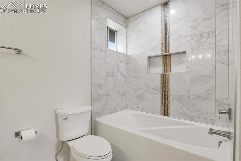 13771 South Hedi Road Sedalia, CO 80135 - Photo 14 of 49 a bathroom with a toilet and a bathtub