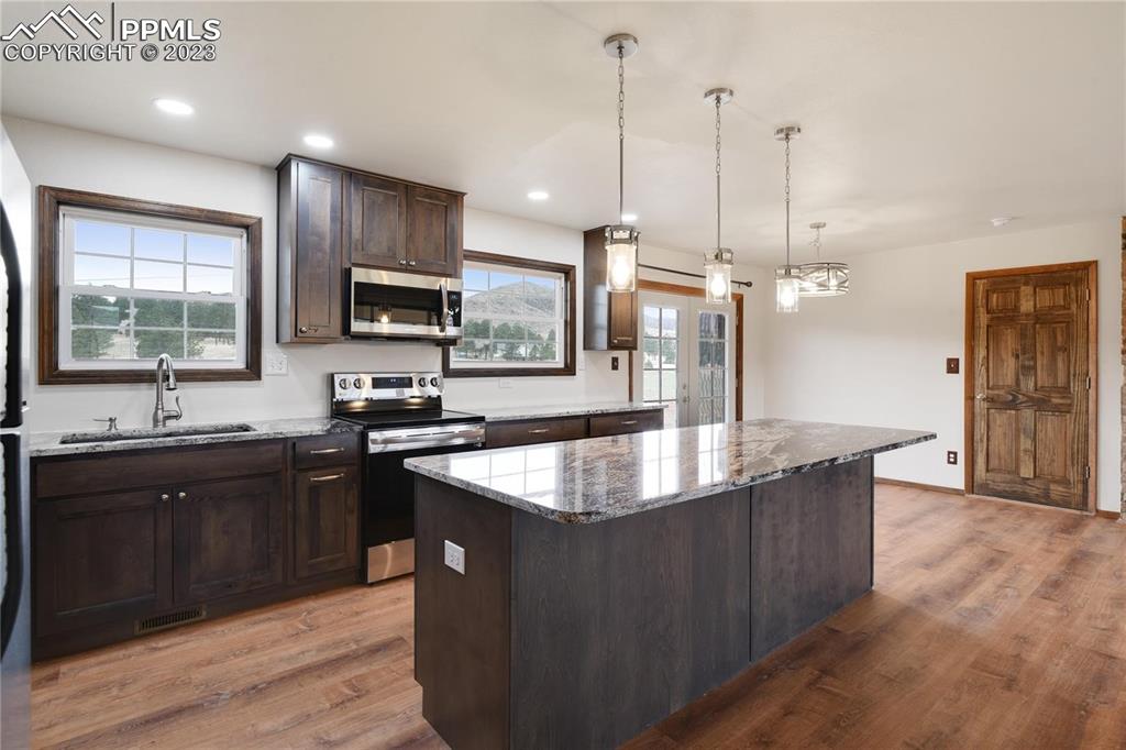 13771 South Hedi Road Sedalia, CO 80135 - Photo 17 of 49 a large kitchen with kitchen island a sink stove and oven