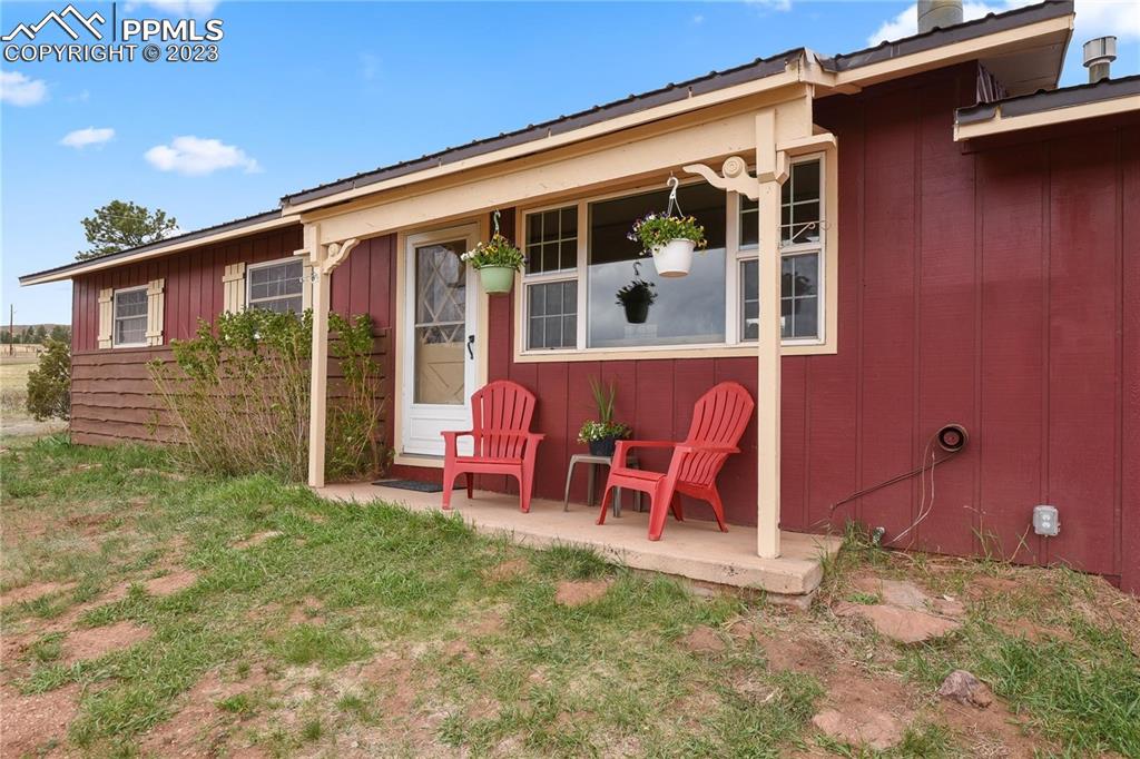 13771 South Hedi Road Sedalia, CO 80135 - Photo 2 of 49 a view of a house with a backyard and sitting area
