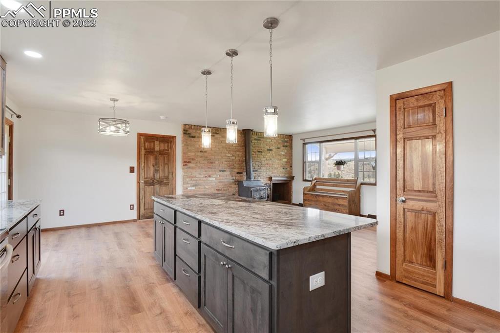 13771 South Hedi Road Sedalia, CO 80135 - Photo 21 of 49 a view of kitchen with refrigerator microwave and wooden floor