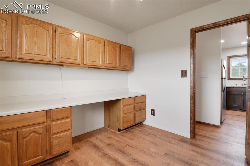 13771 South Hedi Road Sedalia, CO 80135 - Photo 28 of 49 a view of kitchen with granite countertop white cabinets and wooden floor
