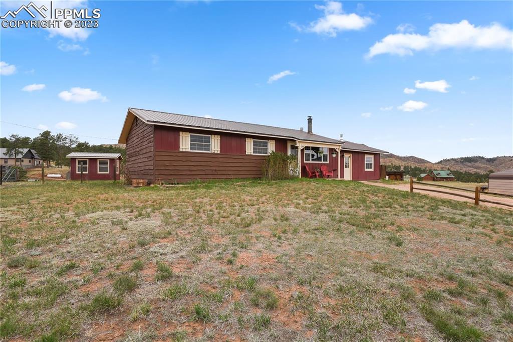 13771 South Hedi Road Sedalia, CO 80135 - Photo 32 of 49 a view of a house with a yard