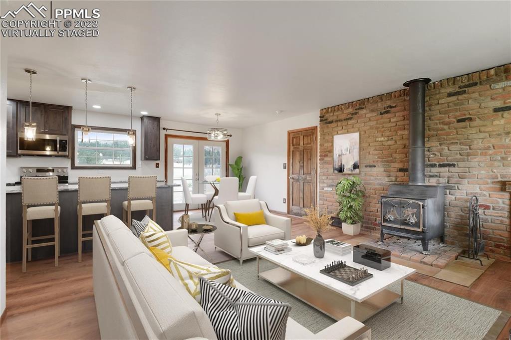 13771 South Hedi Road Sedalia, CO 80135 - Photo 4 of 49 a living room with fireplace furniture and a flat screen tv