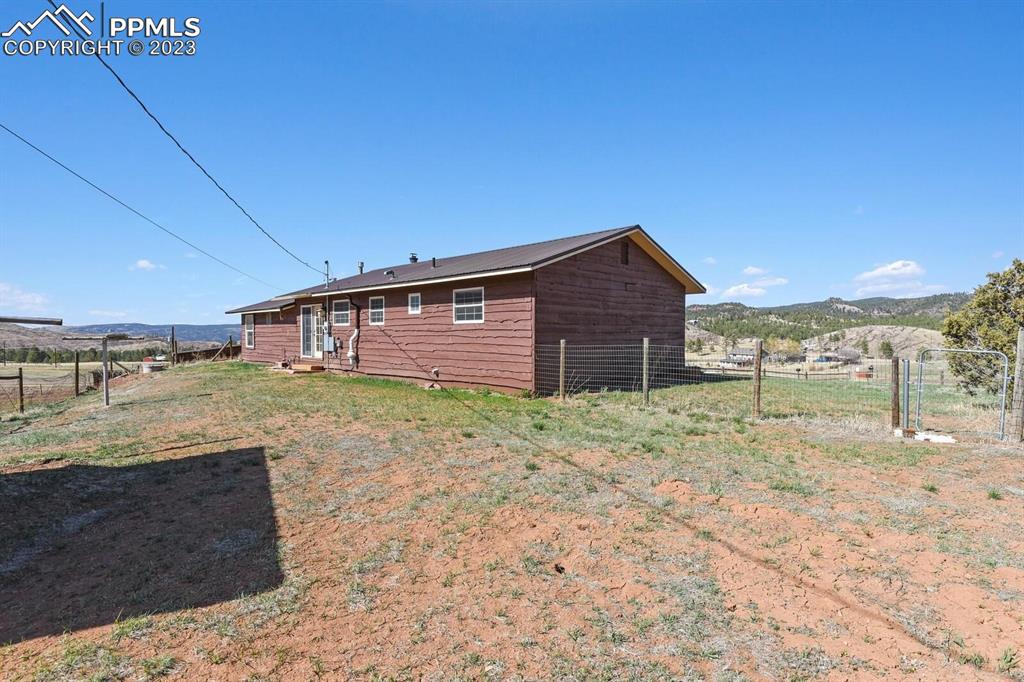 13771 South Hedi Road Sedalia, CO 80135 - Photo 41 of 49 a view of a house with a backyard
