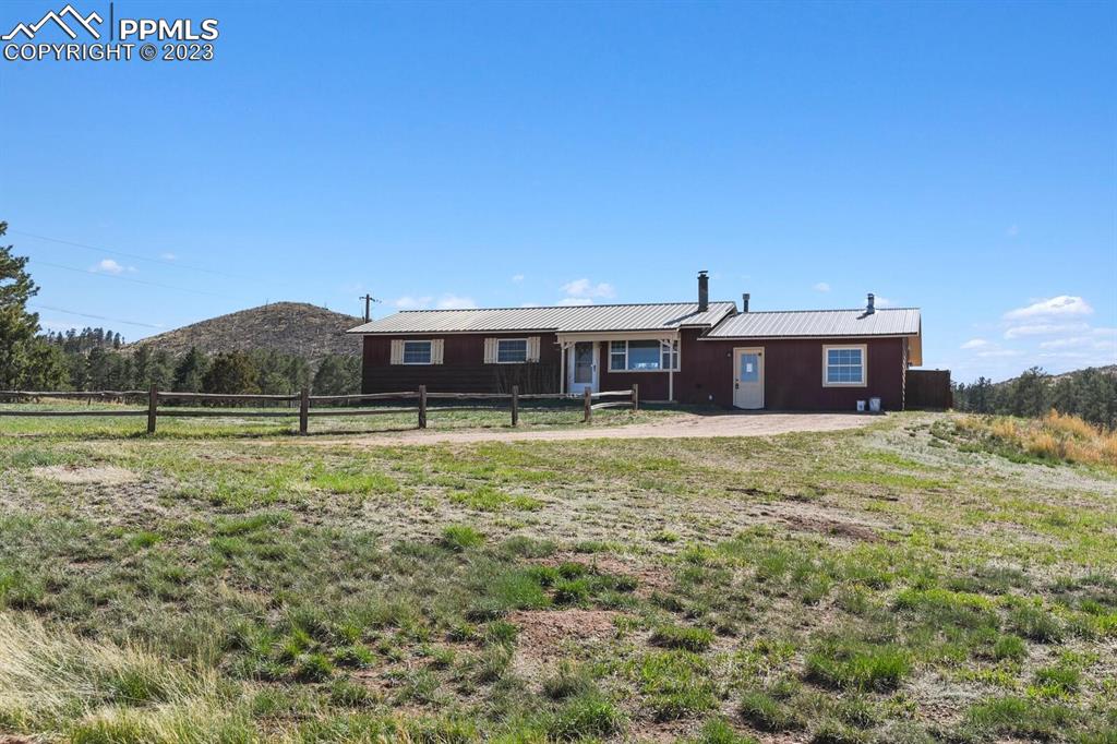 13771 South Hedi Road Sedalia, CO 80135 - Photo 44 of 49 a front view of a house with a garden