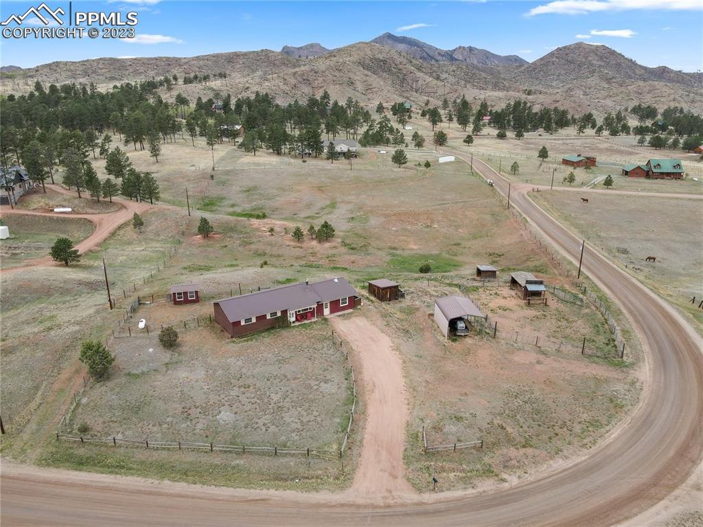 13771 South Hedi Road Sedalia, CO 80135 - Photo 46 of 49 a view of a house with a mountain and a forest