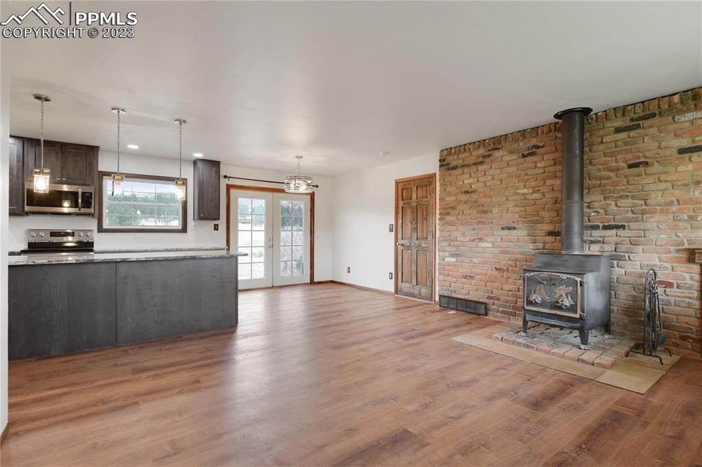 13771 South Hedi Road Sedalia, CO 80135 - Photo 5 of 49 a view of a kitchen with furniture and wooden floor