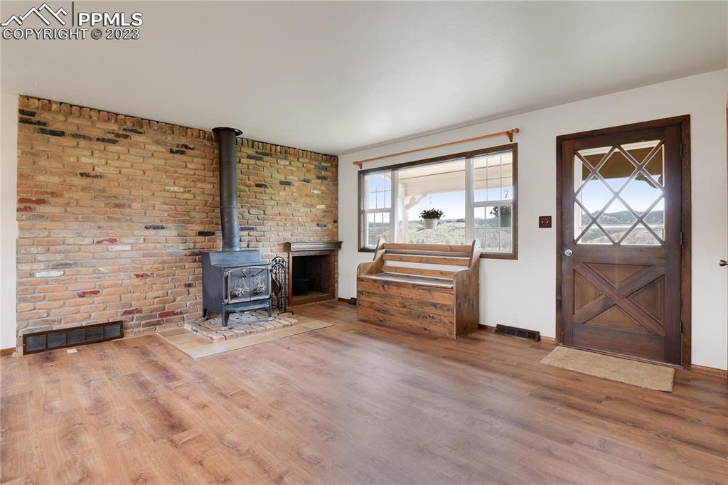 13771 South Hedi Road Sedalia, CO 80135 - Photo 7 of 49 a room with furniture and a fireplace