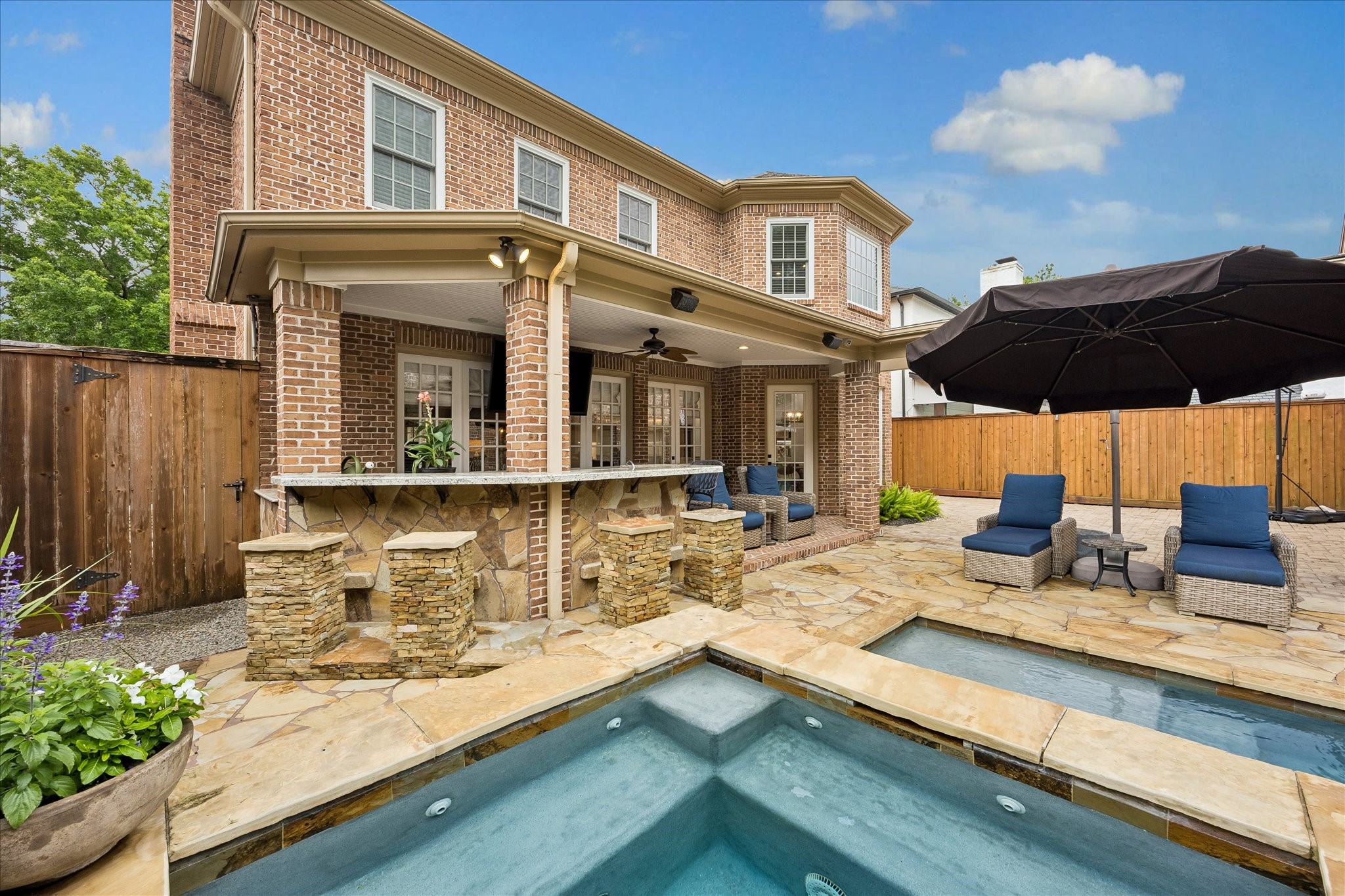 6358 Auden Street Houston, TX 77005 - Photo 40 of 50 a view of a patio with table and chairs under an umbrella with wooden floor