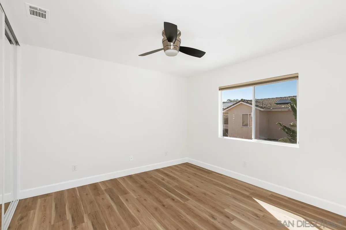 1651 Applegate Street Chula Vista, CA 91913 - Photo 11 of 20 a view of an empty room with wooden floor and a window