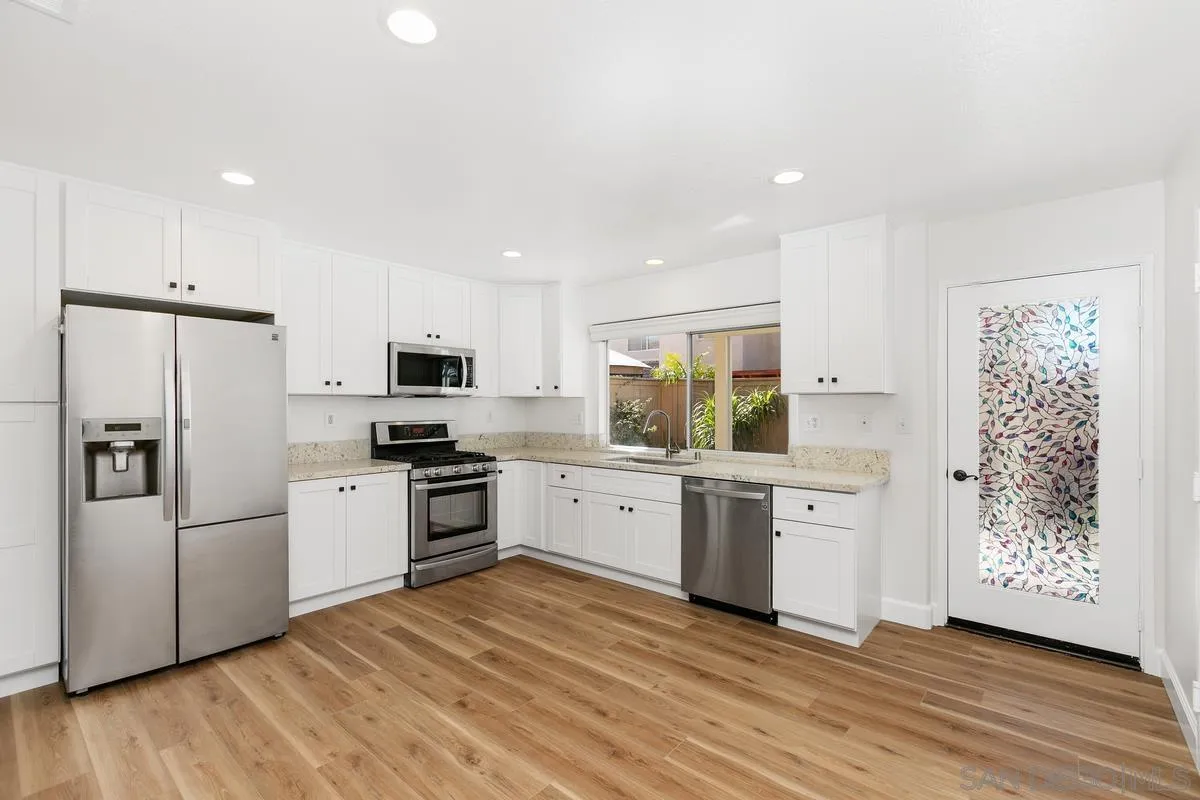 1651 Applegate Street Chula Vista, CA 91913 - Photo 5 of 20 a kitchen with stainless steel appliances a refrigerator sink and microwave