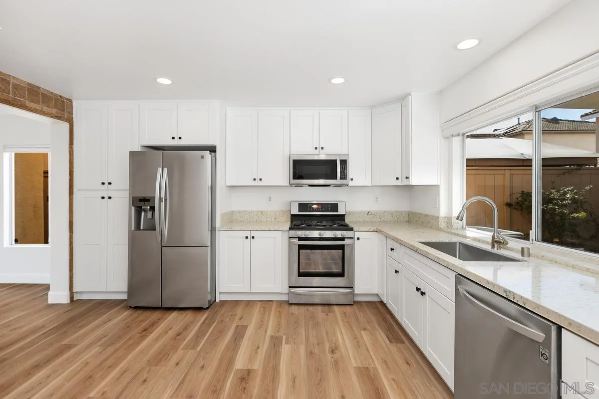 1651 Applegate Street Chula Vista, CA 91913 - Photo 6 of 20 a kitchen with stainless steel appliances granite countertop a refrigerator sink and stove