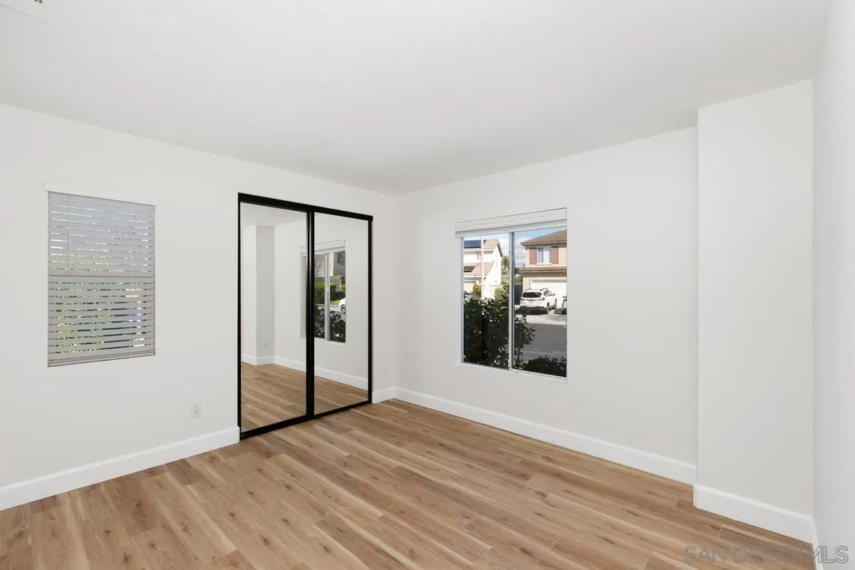 1651 Applegate Street Chula Vista, CA 91913 - Photo 7 of 20 a view of an empty room with wooden floor and a window