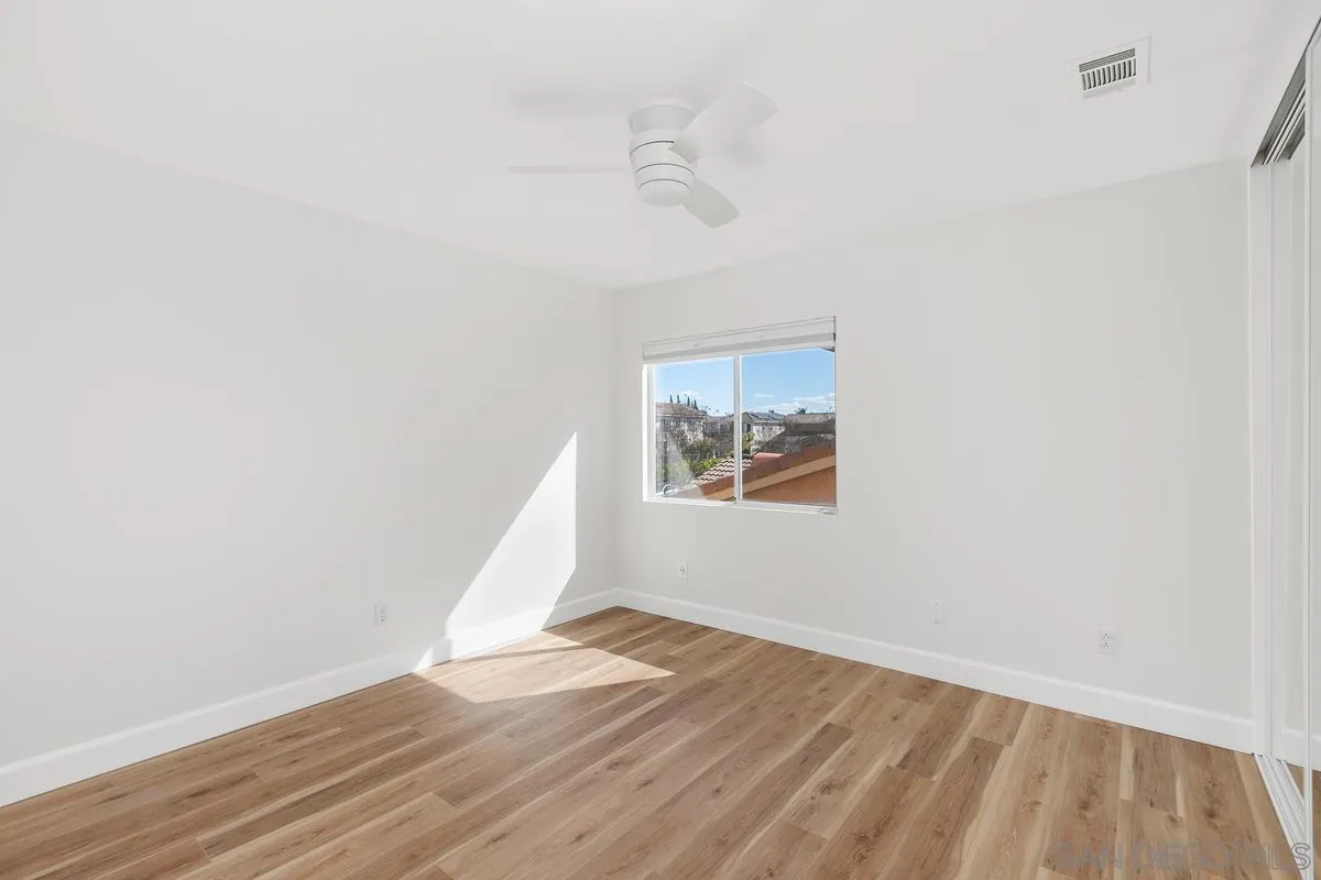 1651 Applegate Street Chula Vista, CA 91913 - Photo 10 of 20 an empty room with wooden floor and windows