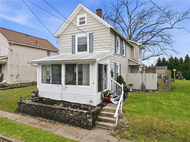 a front view of a house with garden and porch