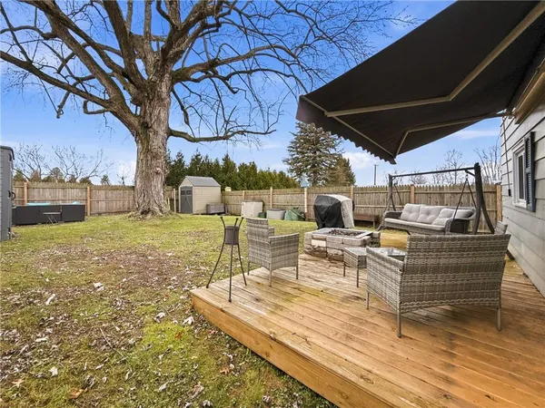 a view of a patio with a table chairs and a fire pit