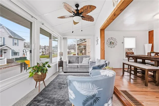 a living room with furniture a couch and a chandelier
