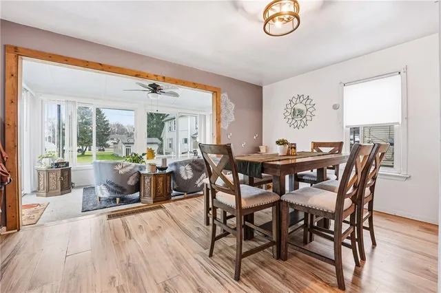 a dining room with furniture a window and wooden floor
