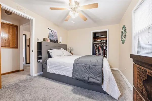 a bedroom with a bed and a fireplace