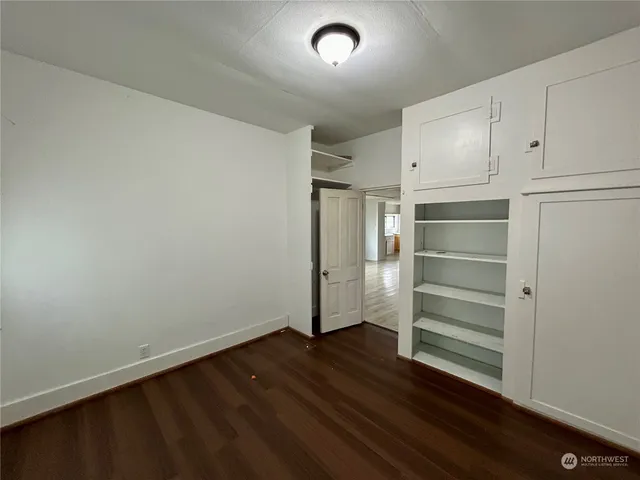 a view of walk in closet with empty racks