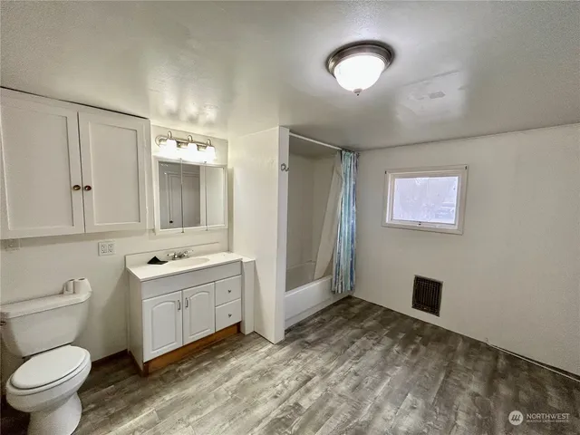 a bathroom with a toilet sink and mirror