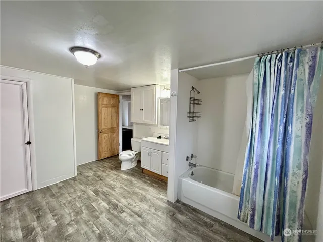 a bathroom with a bathtub and a shower