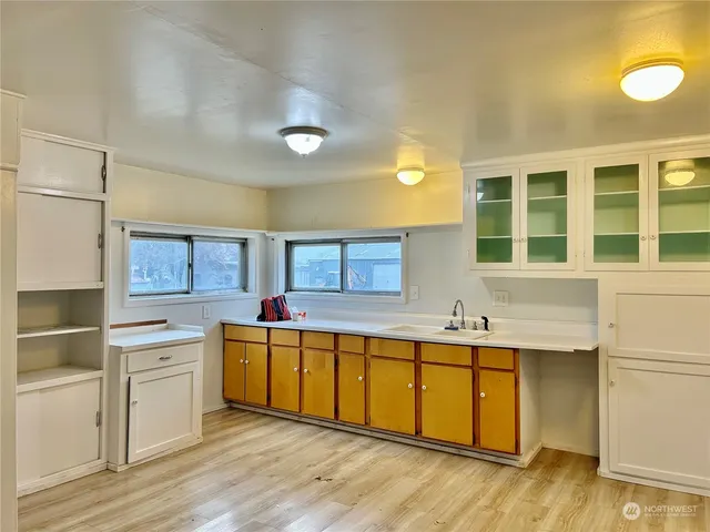 a kitchen with a sink and wooden cabinets