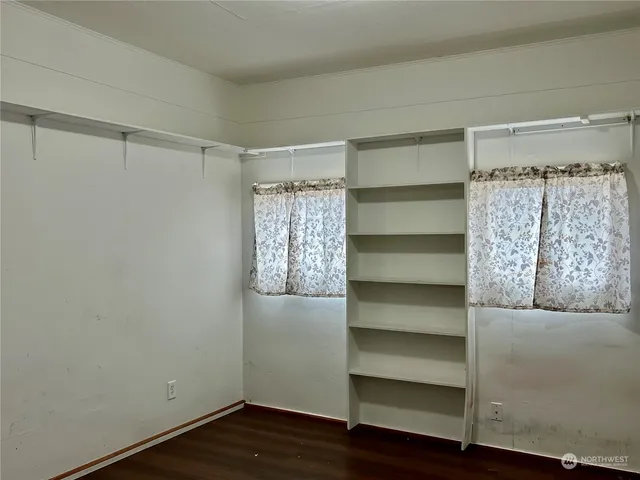 a view of walk in closet with empty racks