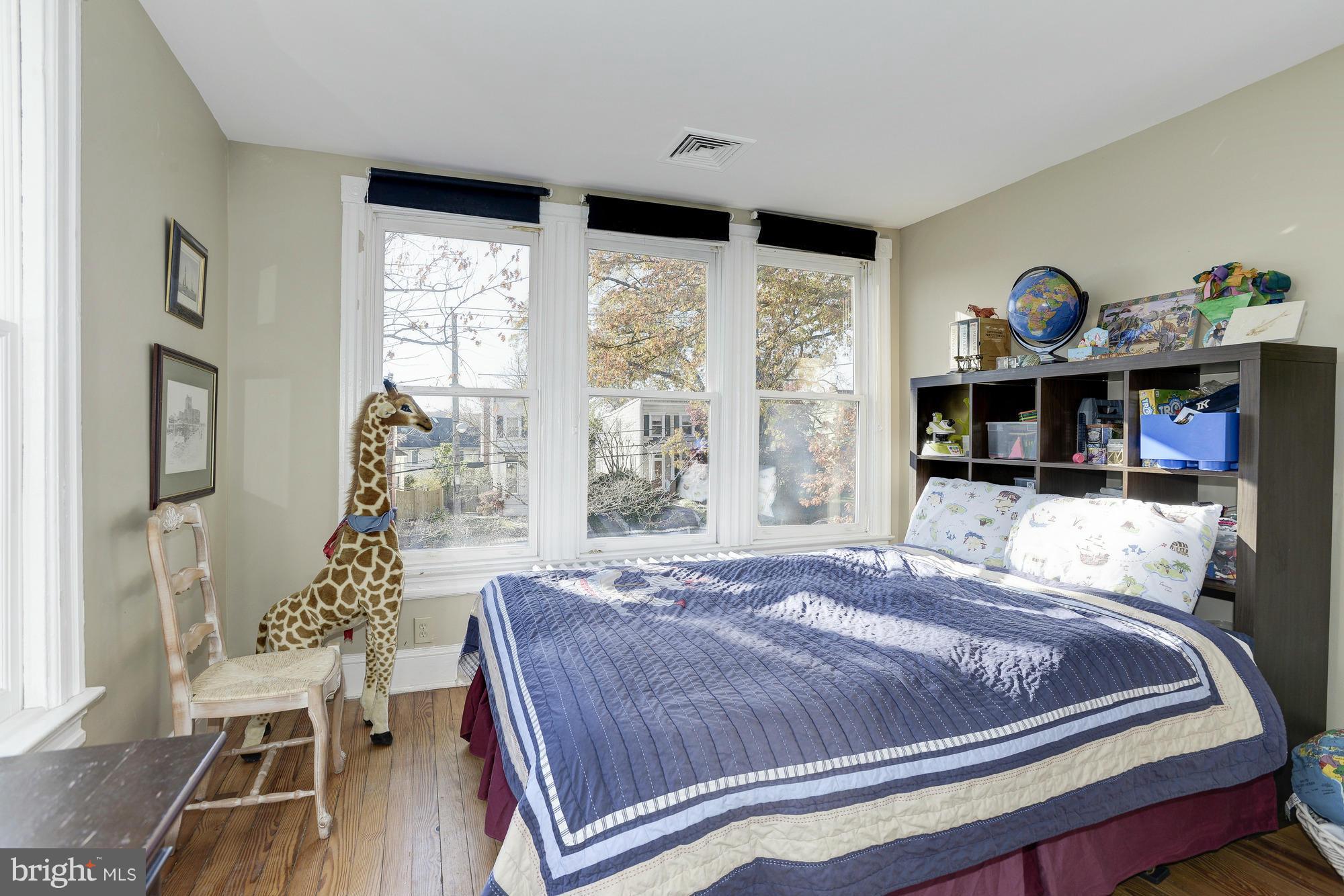 1419 Foxhall Road Northwest Washington, DC 20007 - Photo 12 of 19 a bedroom with a bed and wooden floor