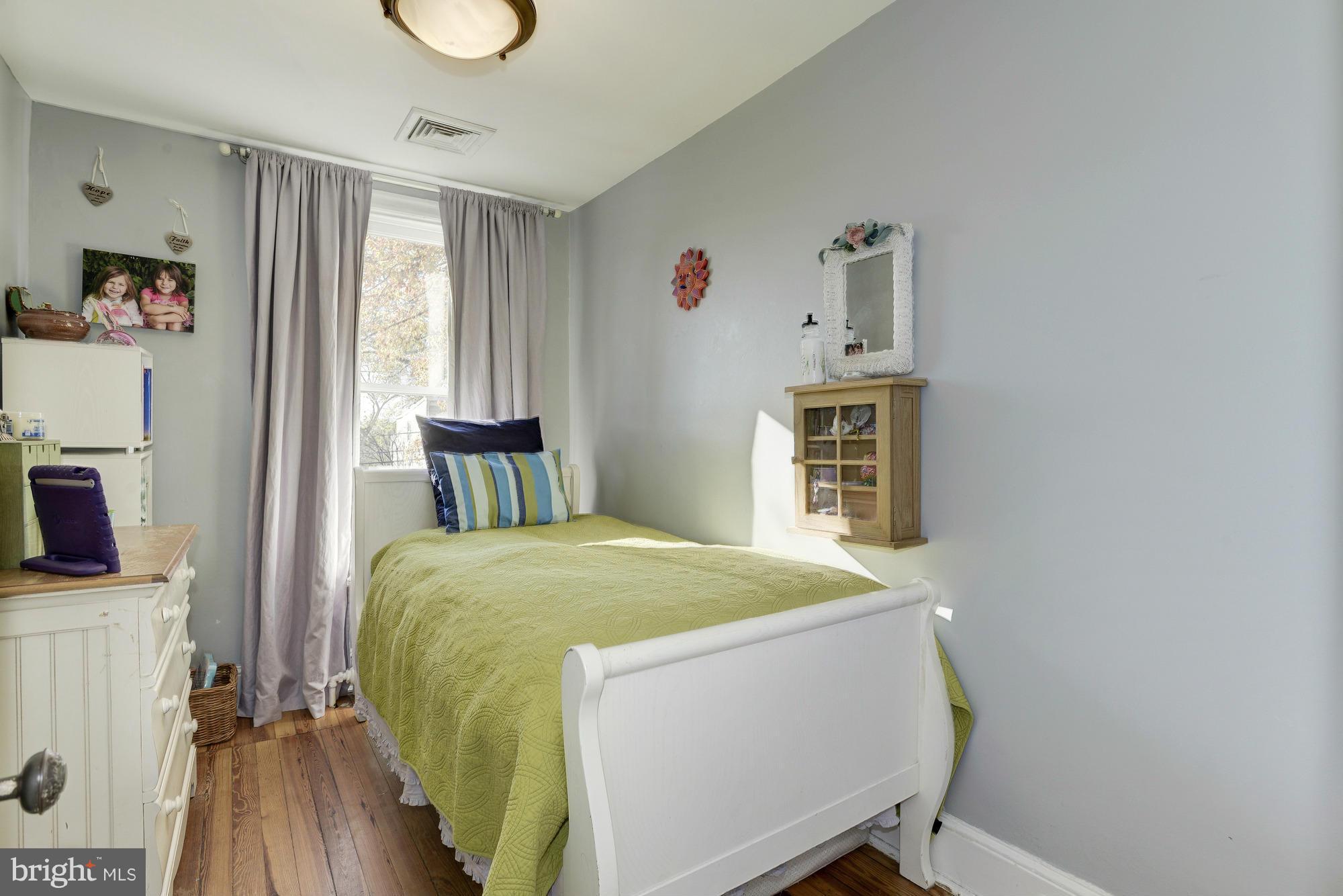 1419 Foxhall Road Northwest Washington, DC 20007 - Photo 13 of 19 a bed room with a bed and a window