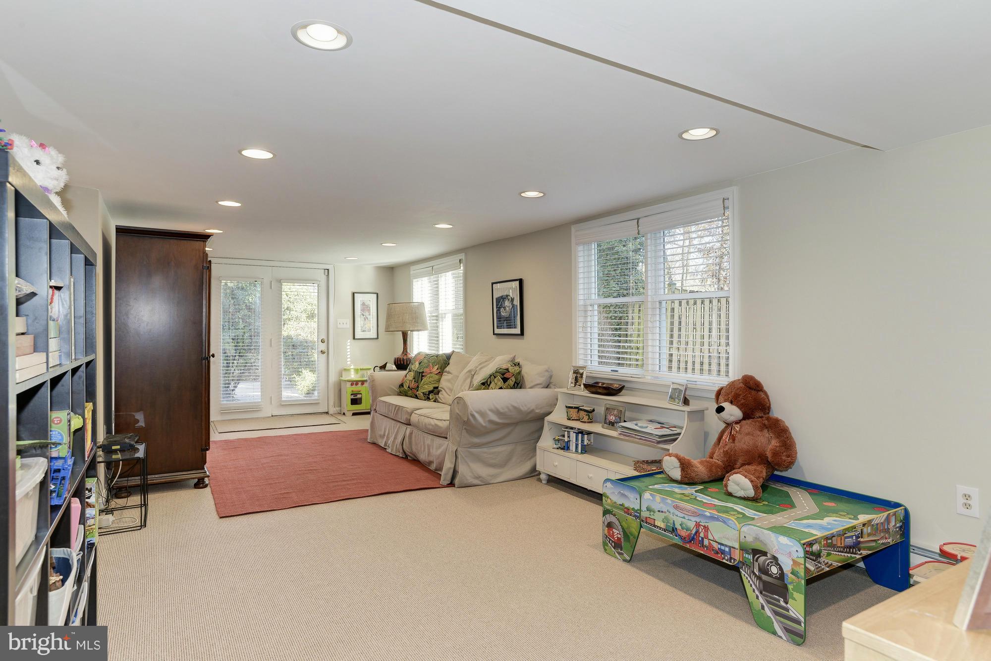 1419 Foxhall Road Northwest Washington, DC 20007 - Photo 14 of 19 a living room with furniture hard wood floor and a flat screen tv