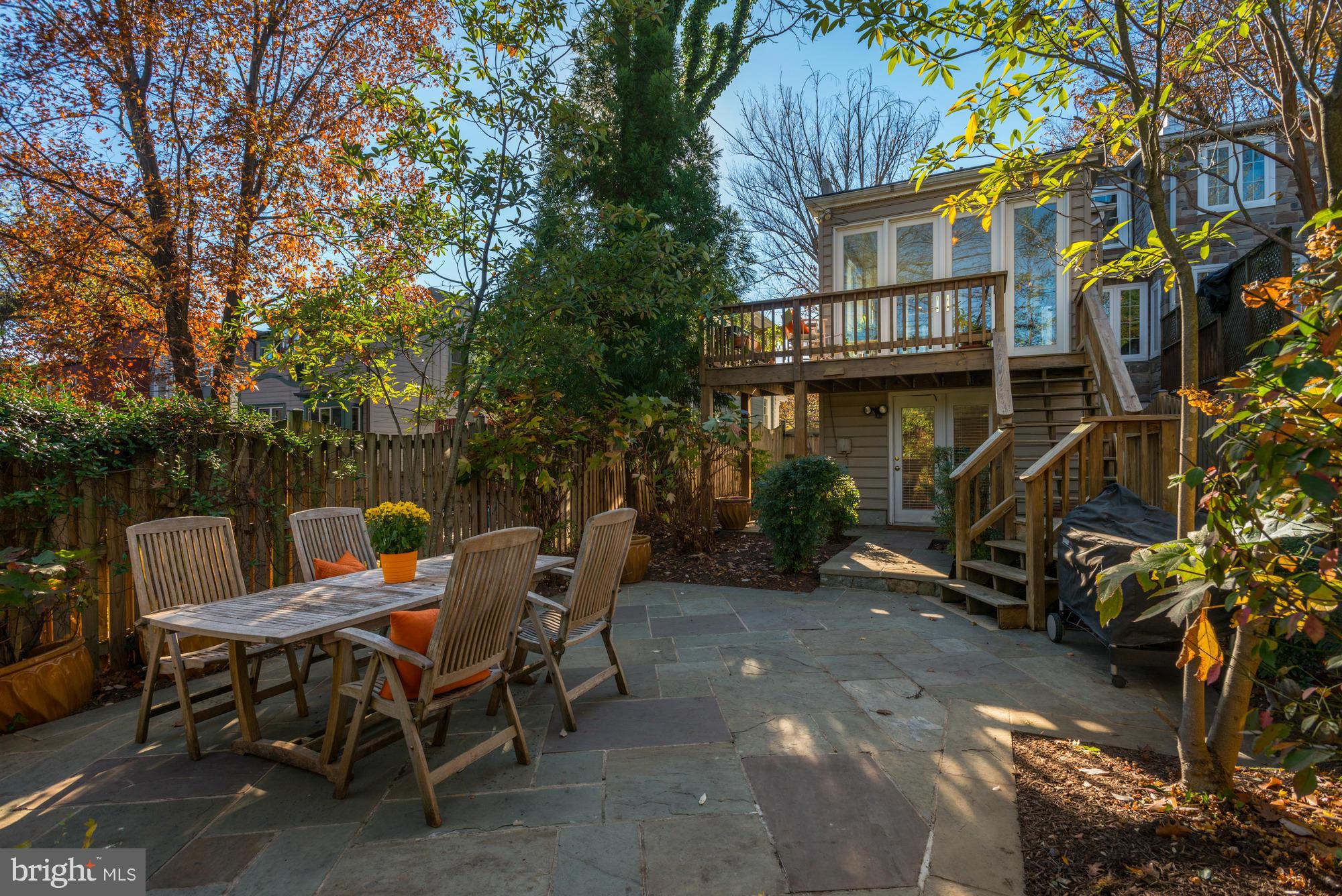 1419 Foxhall Road Northwest Washington, DC 20007 - Photo 17 of 19 a view of a patio with table and chairs and wooden fence