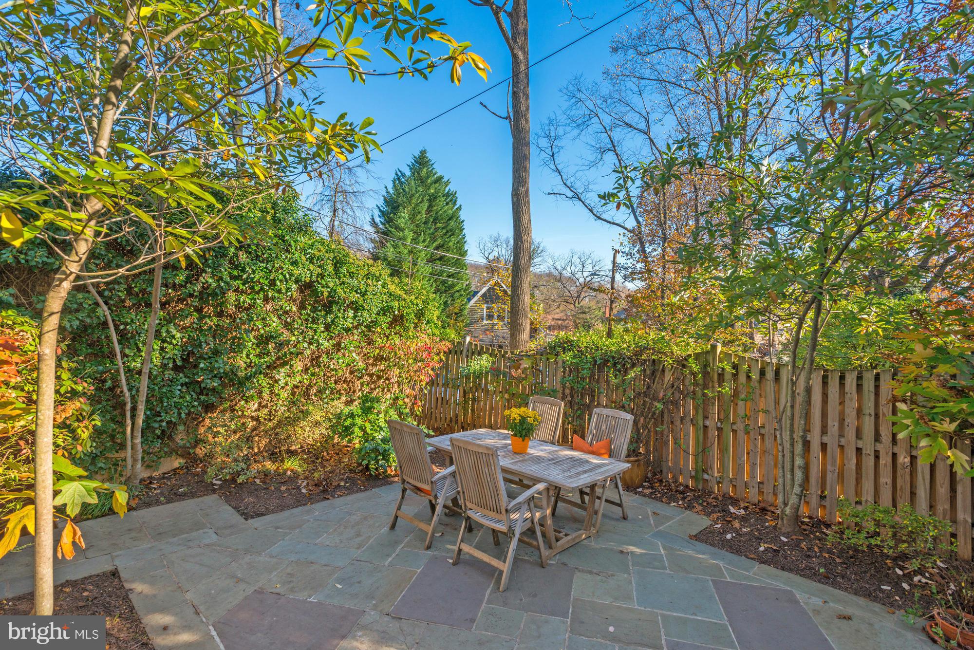 1419 Foxhall Road Northwest Washington, DC 20007 - Photo 18 of 19 a view of a patio with table and chairs and potted plants