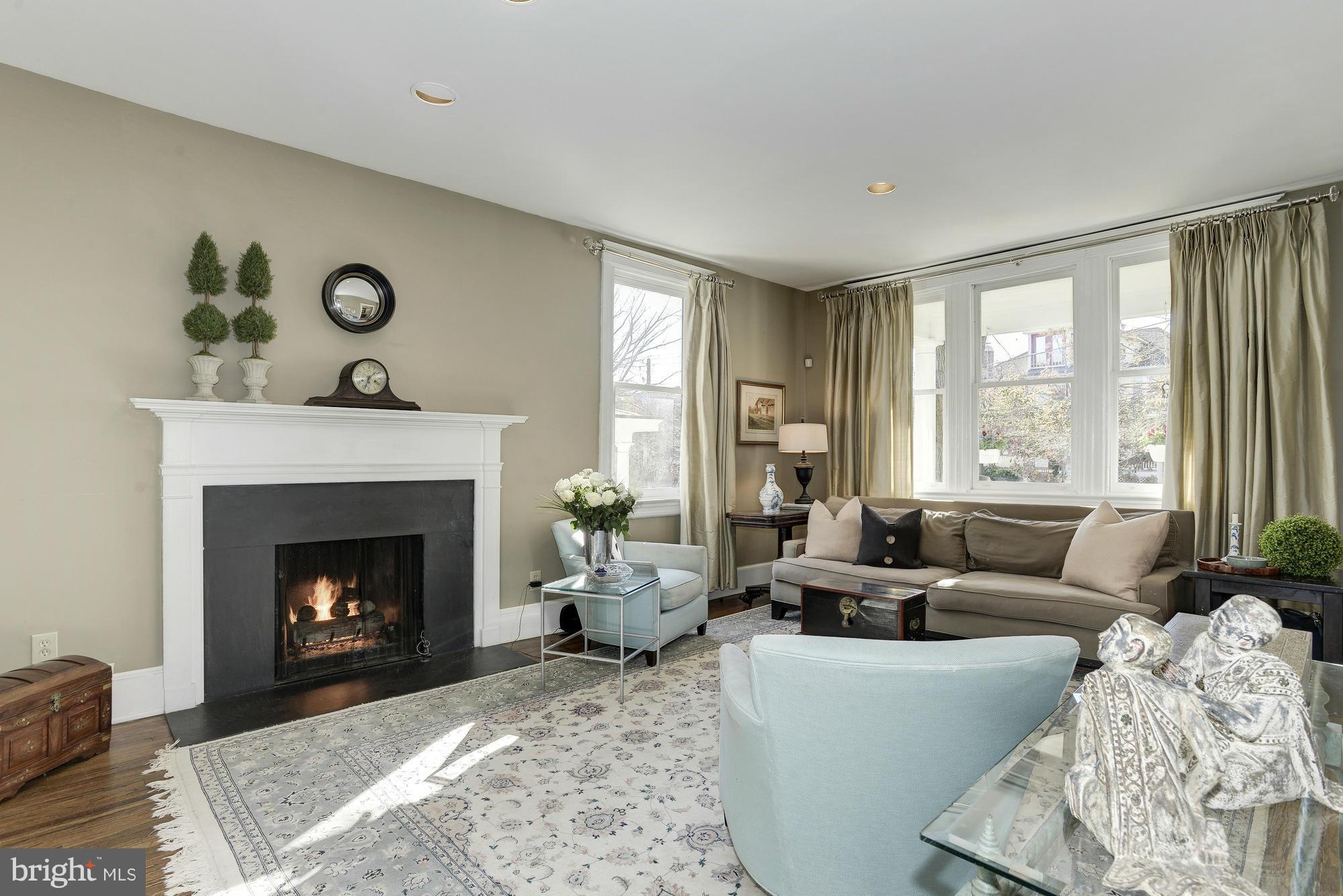 1419 Foxhall Road Northwest Washington, DC 20007 - Photo 4 of 19 a living room with furniture and a fireplace