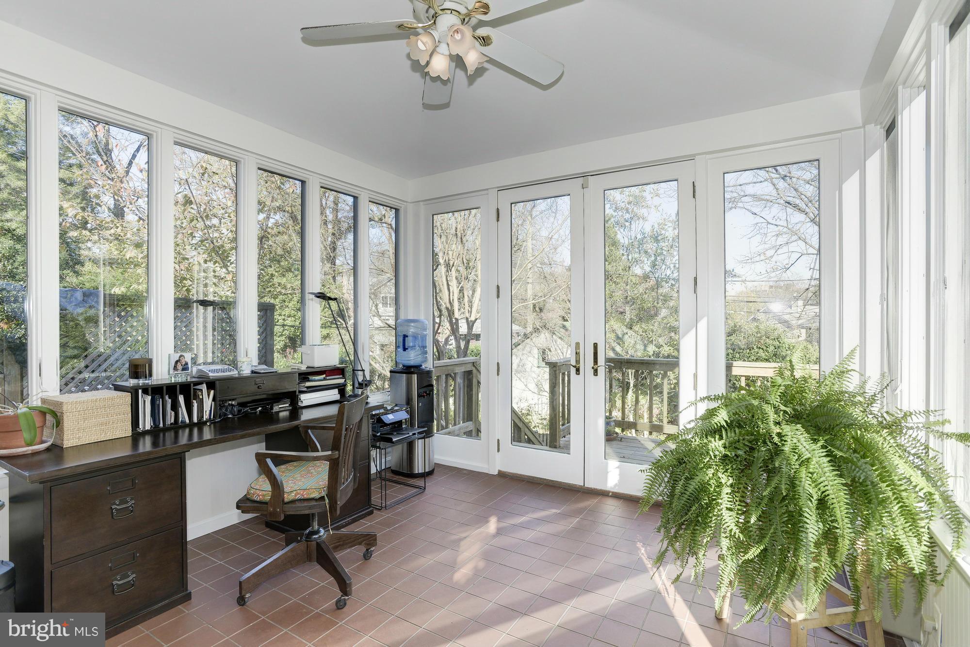 1419 Foxhall Road Northwest Washington, DC 20007 - Photo 8 of 19 a view of a livingroom with workspace and windows