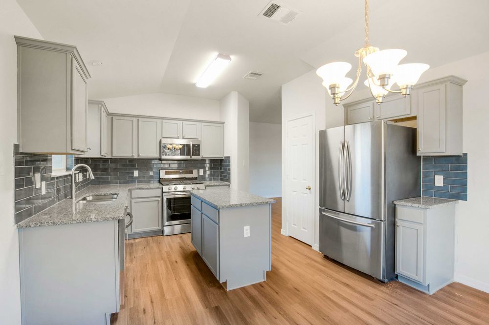 3310 Blue Ridge Drive Round Rock, TX 78681 - Photo 4 of 13 Culinary delights await in this modern kitchen with sleek cabinetry and a functional island.