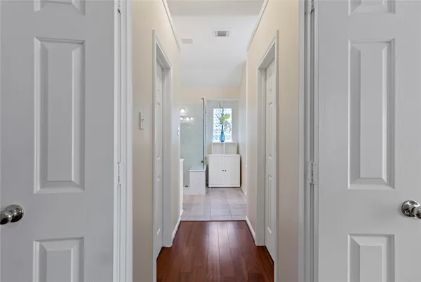a view of a hallway with wooden floor