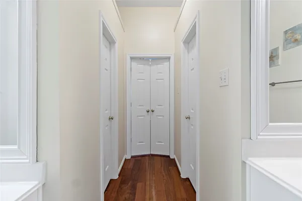 a view of a hallway with a white walls and a white door