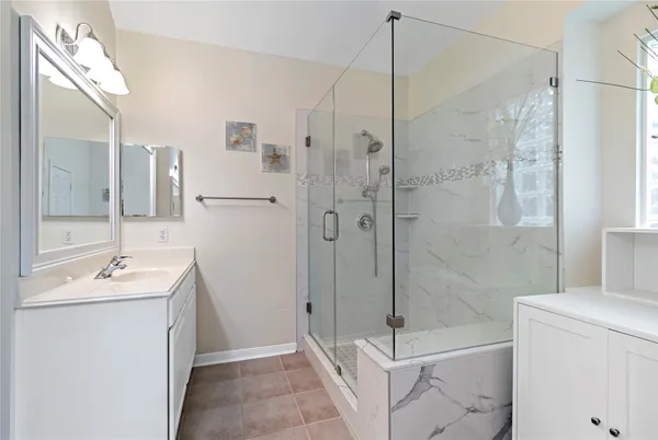 a bathroom with a shower sink and mirror