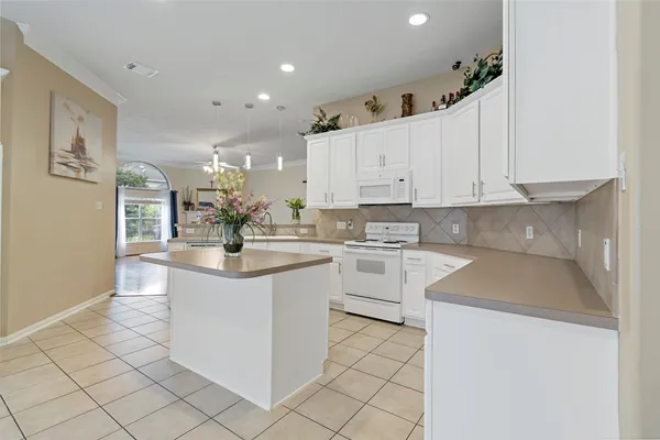 a kitchen with white cabinets appliances and a sink