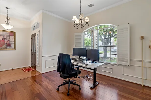 a view of a workspace with furniture and a window