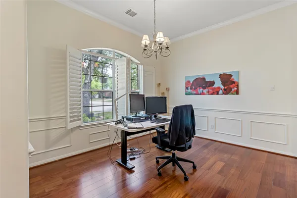 a view of a workspace with furniture and a window