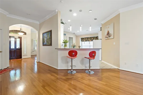 a room with gym equipment and wooden floor