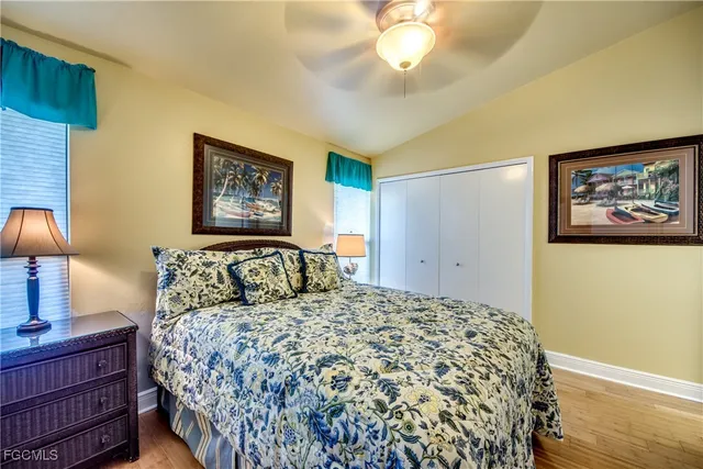 a bedroom with a bed and a lamp on dresser