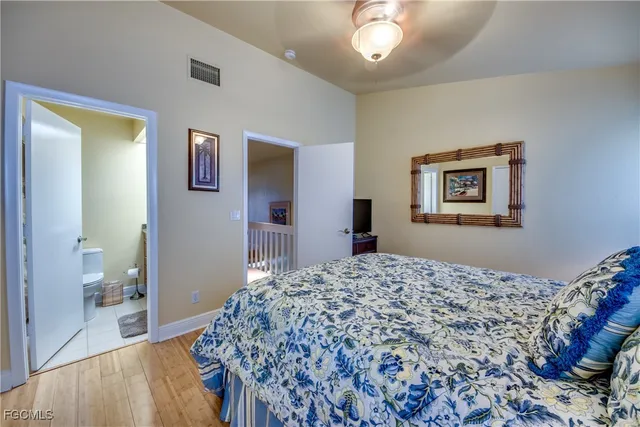 a living room with a bed and a dresser