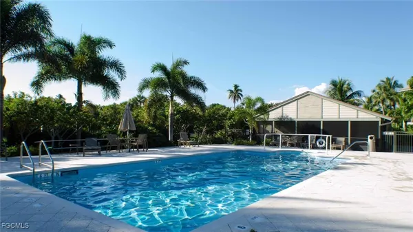 a swimming pool with outdoor seating and yard