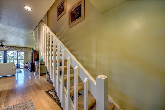 a view of staircase with wooden floor and furniture