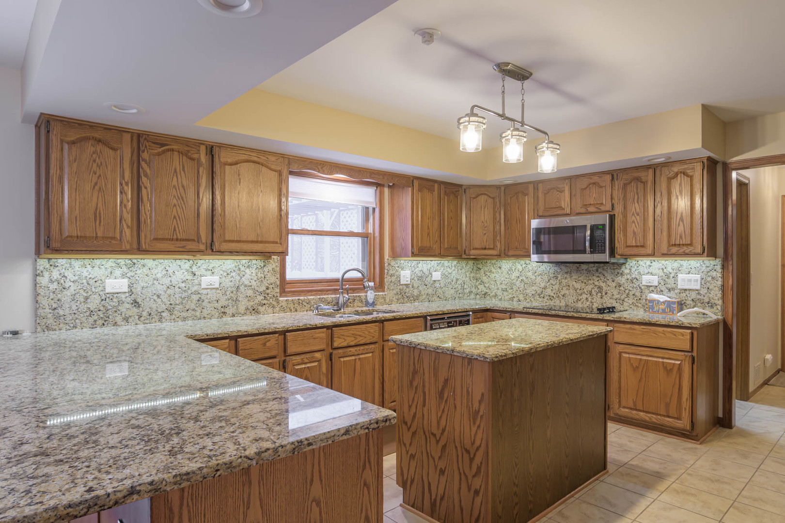1995 Salem Road Elgin, IL 60123 - Photo 12 of 29 a kitchen with stainless steel appliances granite countertop a sink stove and cabinets