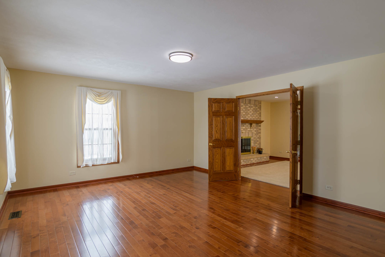 1995 Salem Road Elgin, IL 60123 - Photo 4 of 29 an empty room with wooden floor and windows
